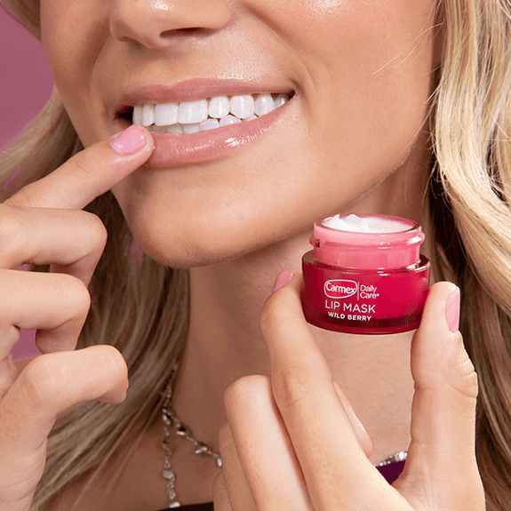 Female applying wild berry lip mask